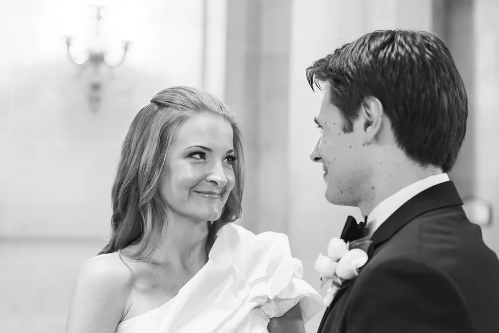 Bride smiles at groom during ceremony