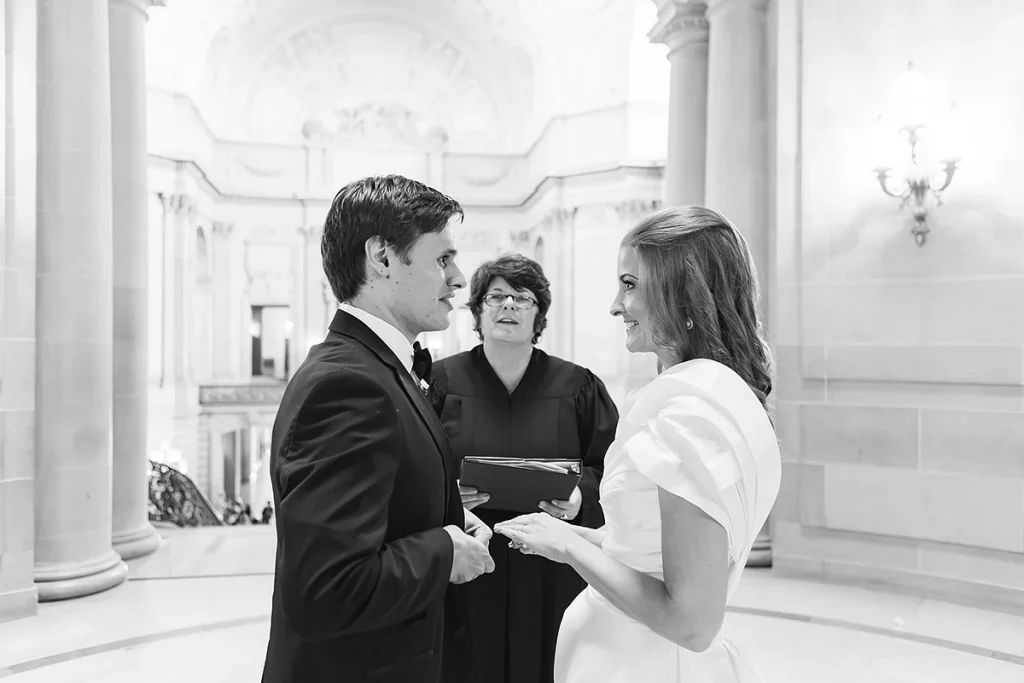 Bride and groom smile during City Hall SF wedding ceremony