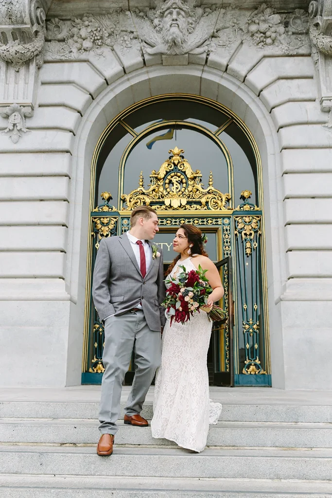 Bride and groom walk downstairs together