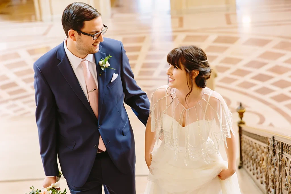 Bride and groom walking up the Grand Staircase