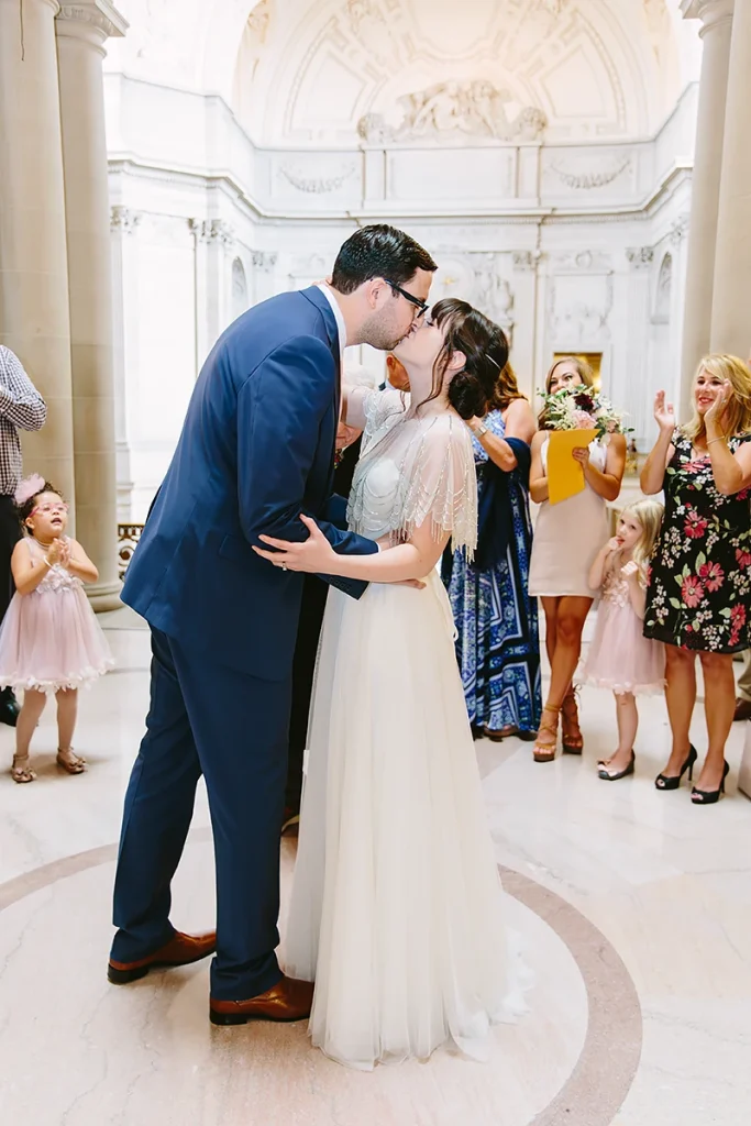 Bride and groom kiss at their City Hall SF wedding