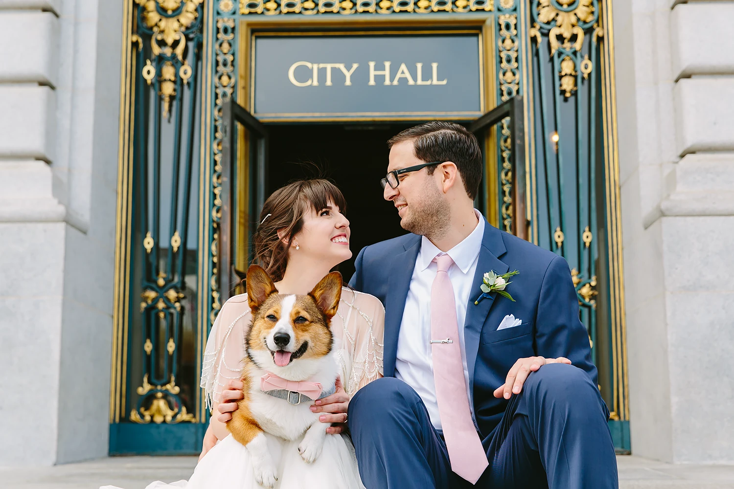 Bride and groom sitting with their dog at their City Hall SF wedding