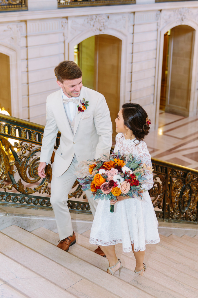 Smiling couple walk upstairs
