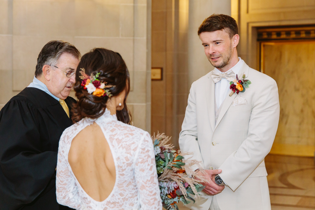 Groom looks at bride during wedding ceremony
