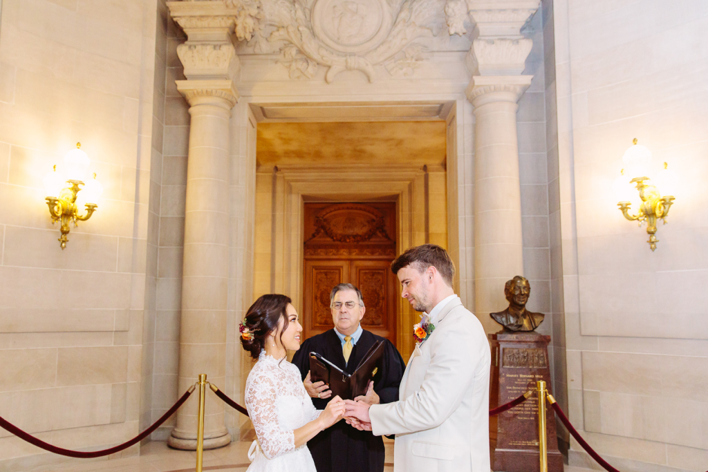 Couple hold hands and exchange wedding vows