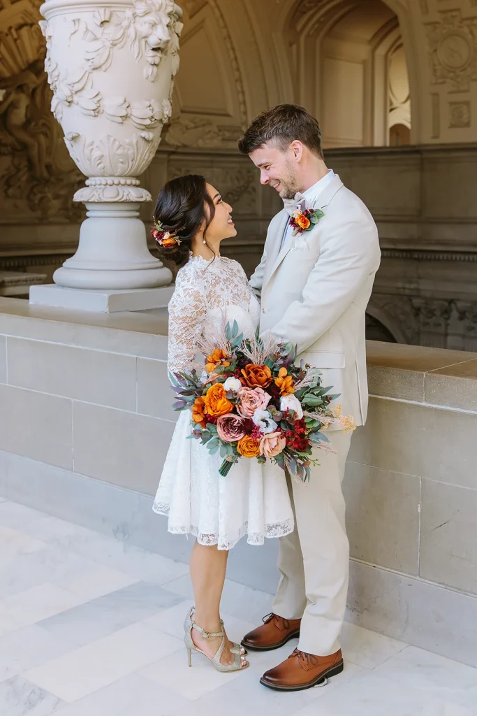 Bride and groom hold each other and smile
