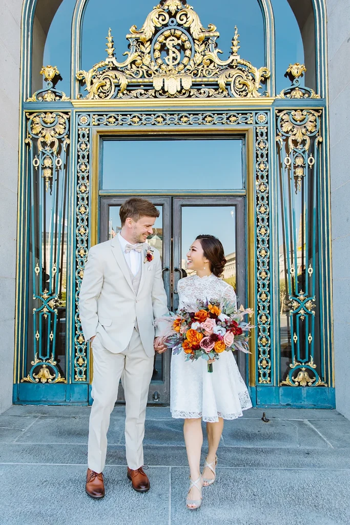 Couple walk together at City Hall SF elopement
