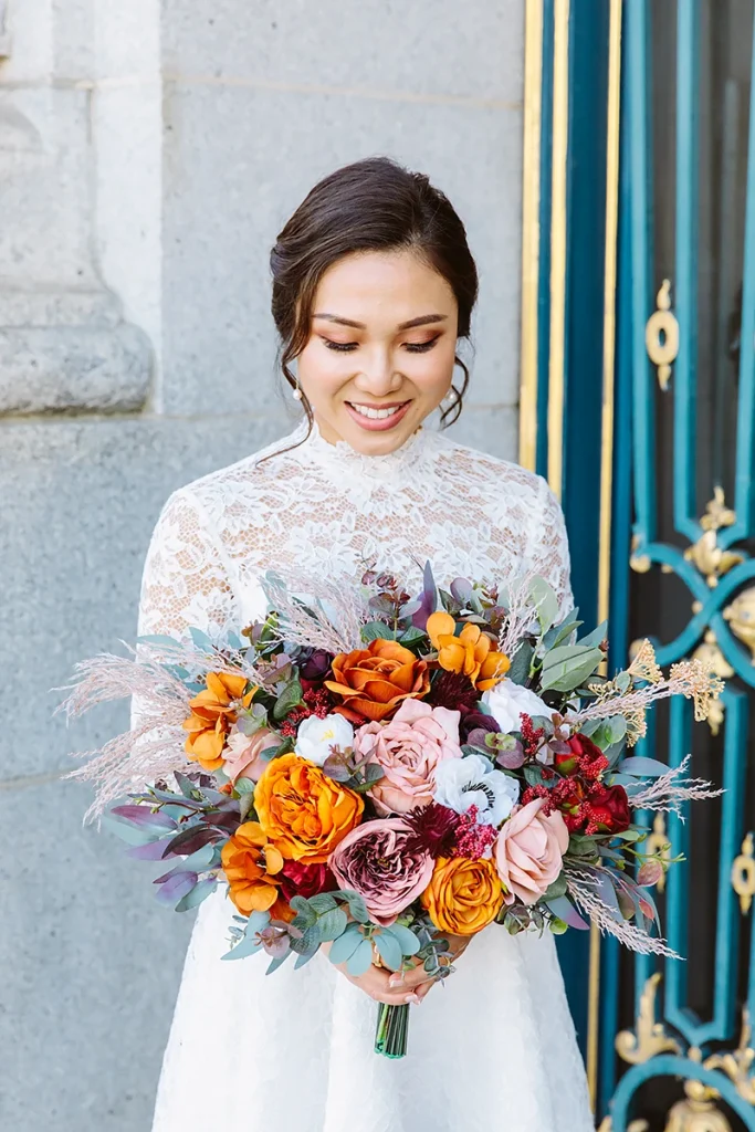 Bride looks down at her bridal bouquet