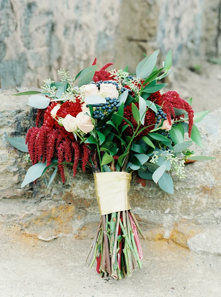 Bridal bouquet with burgundy red, white, and dark purple color palette