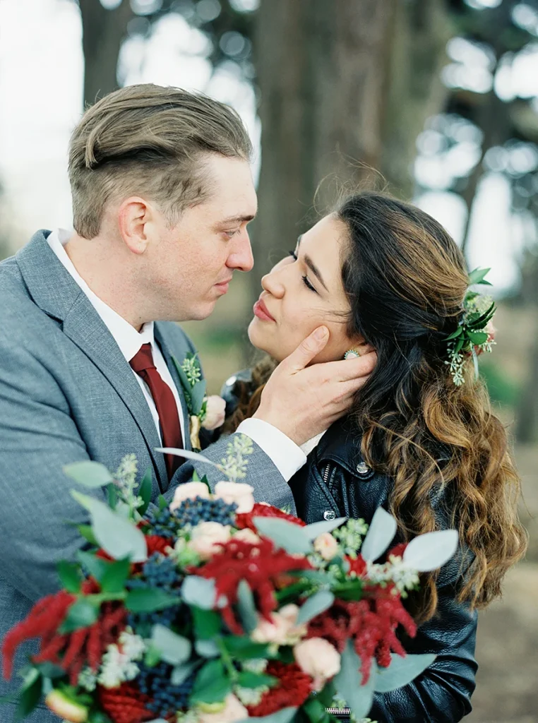 Groom caresses the face of his bride