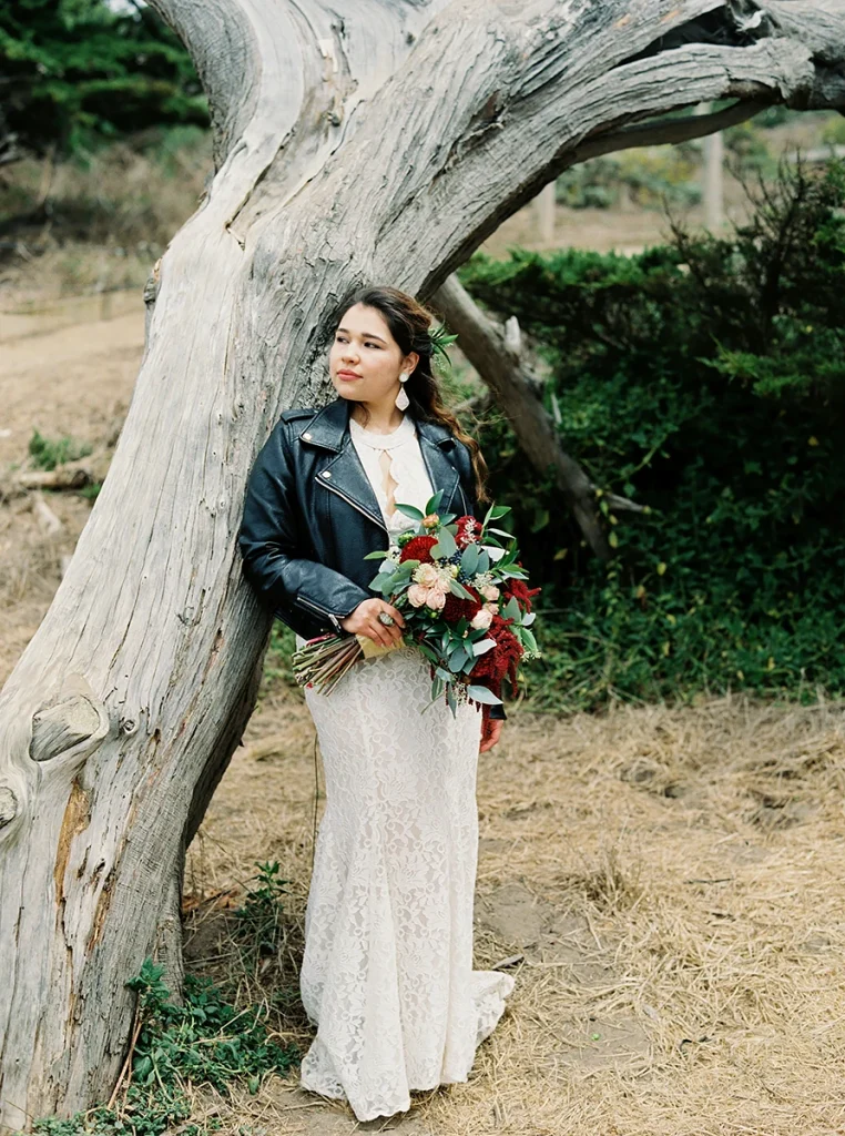 Bride leaning on tree