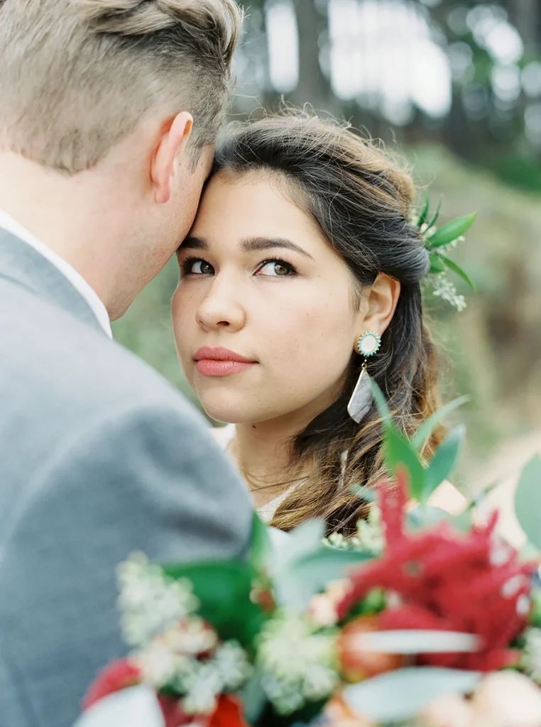 Groom hugs bride as she looks up