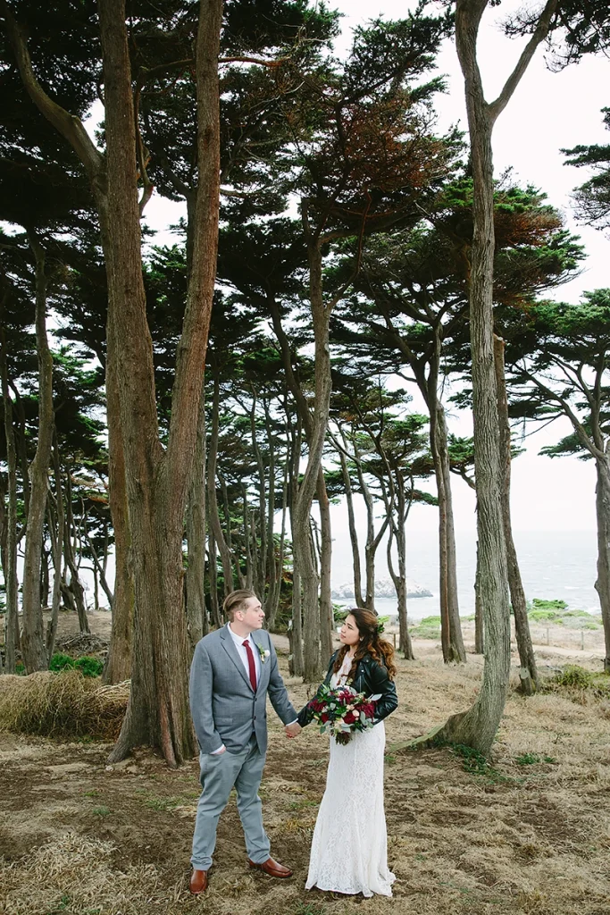 Bride and groom with tall trees in background