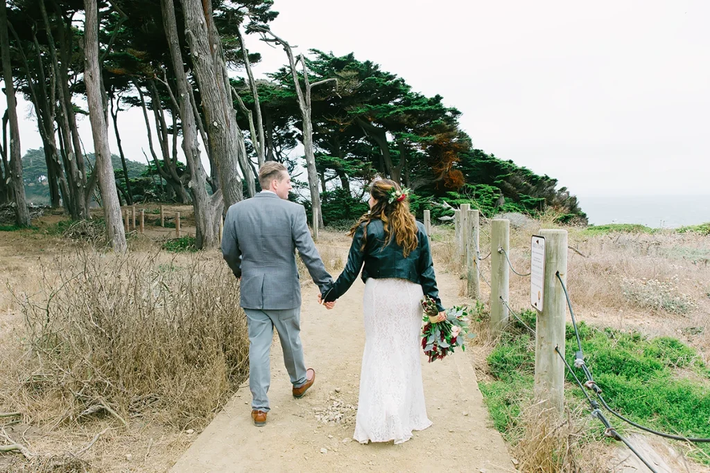Couple walk towards the ocean