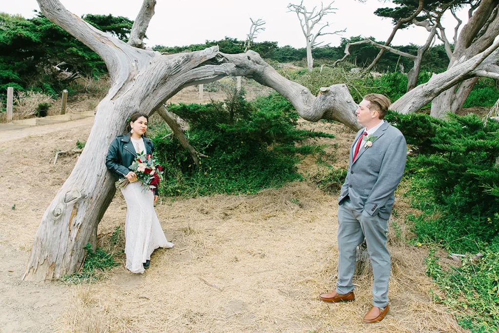 Couple stand next to a cypress tree