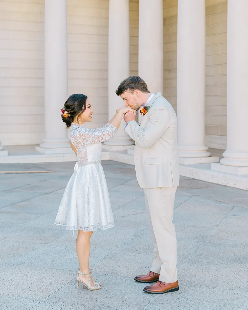 Groom kisses the hand of his bride