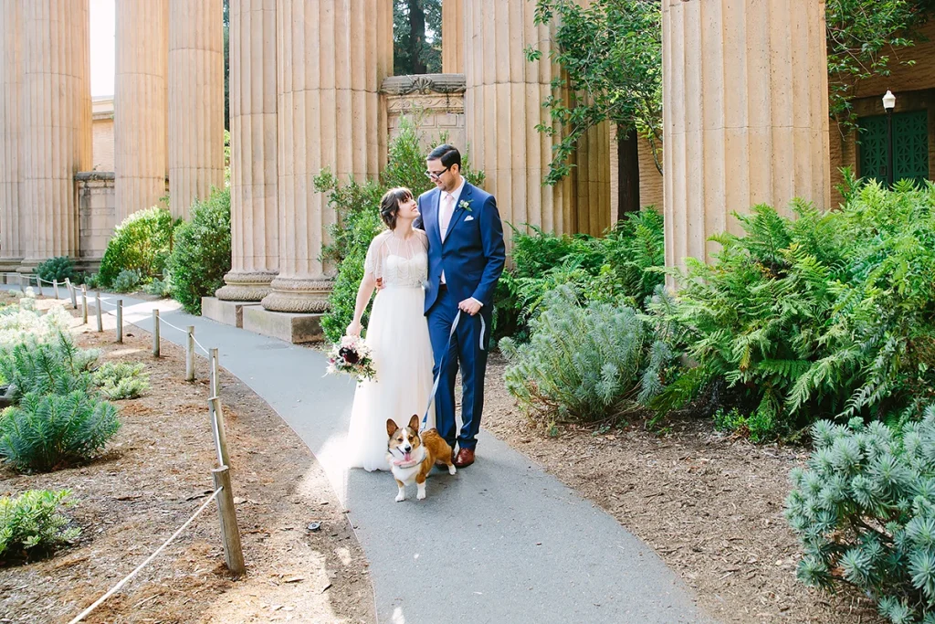 Bride and groom walk with their dog at the Palace of Fine Arts San Francisco