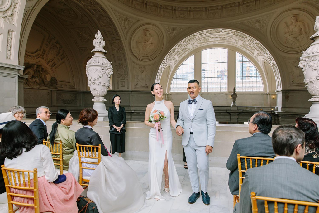 Bride and groom smiling at their San Francisco City Hall wedding on the Fourth Floor North Gallery