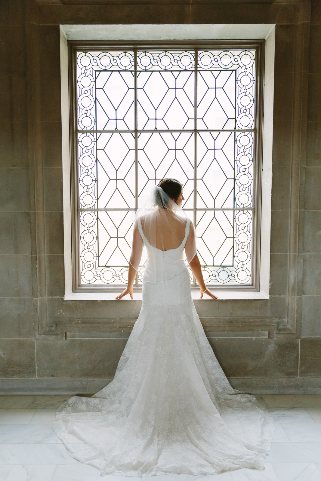 Bride standing in front of window at SF City Hall