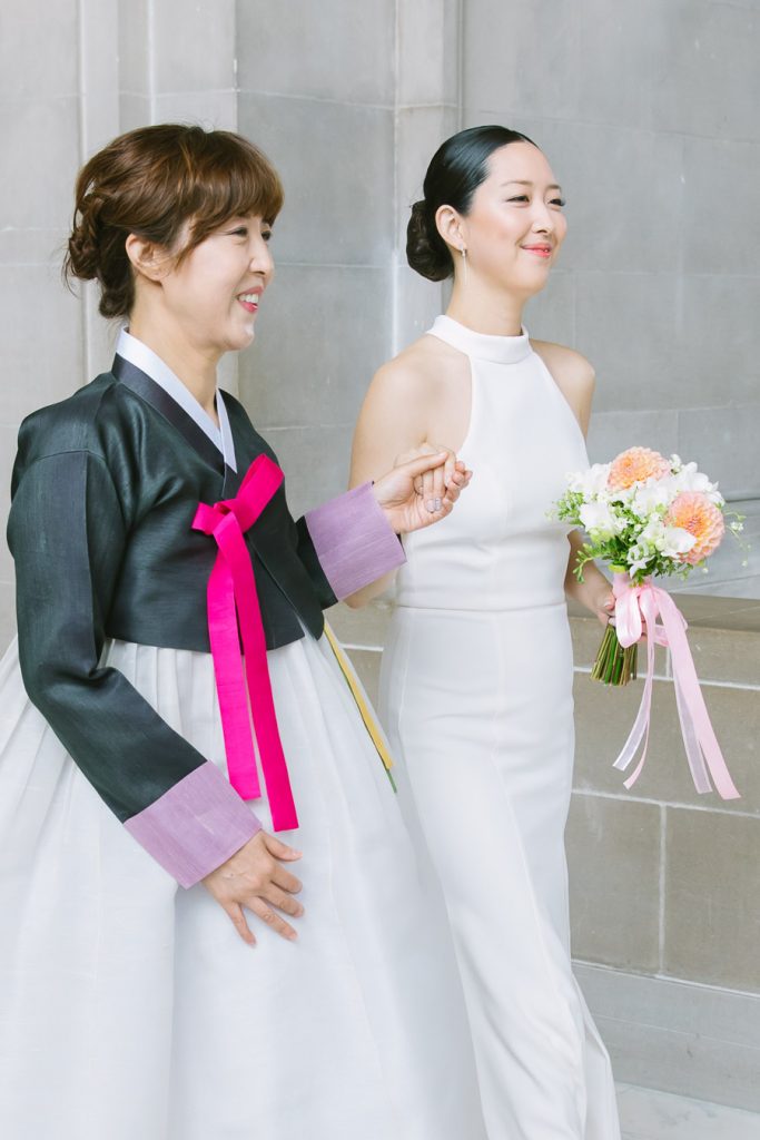 Bride walking down the aisle with her mother at her San Francisco City Hall wedding