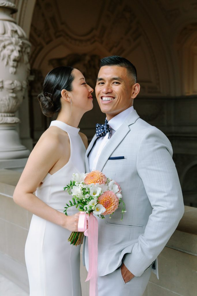 Bride whispering in groom's ear