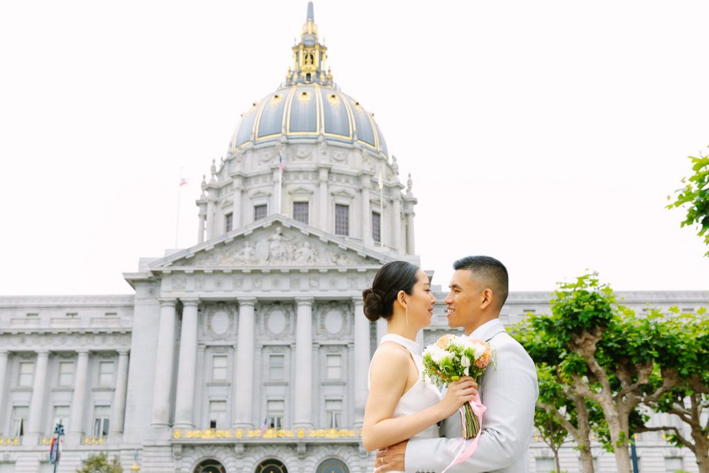 Bride and groom standing in front of Wedding Ceremony on the Fourth Floor at San Francisco City Hall