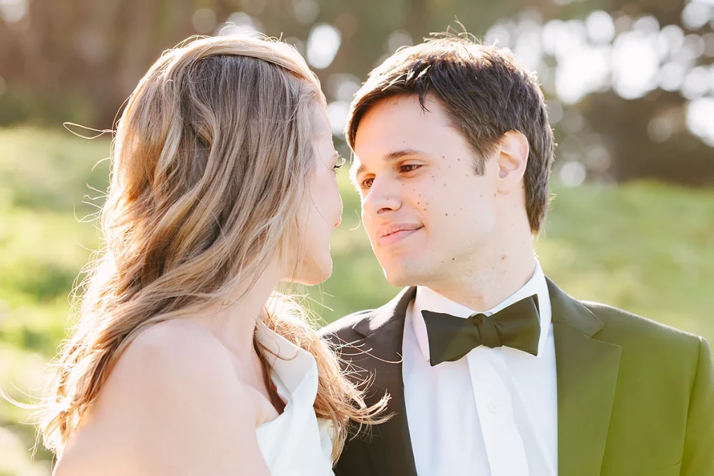Groom looks lovingly at his bride