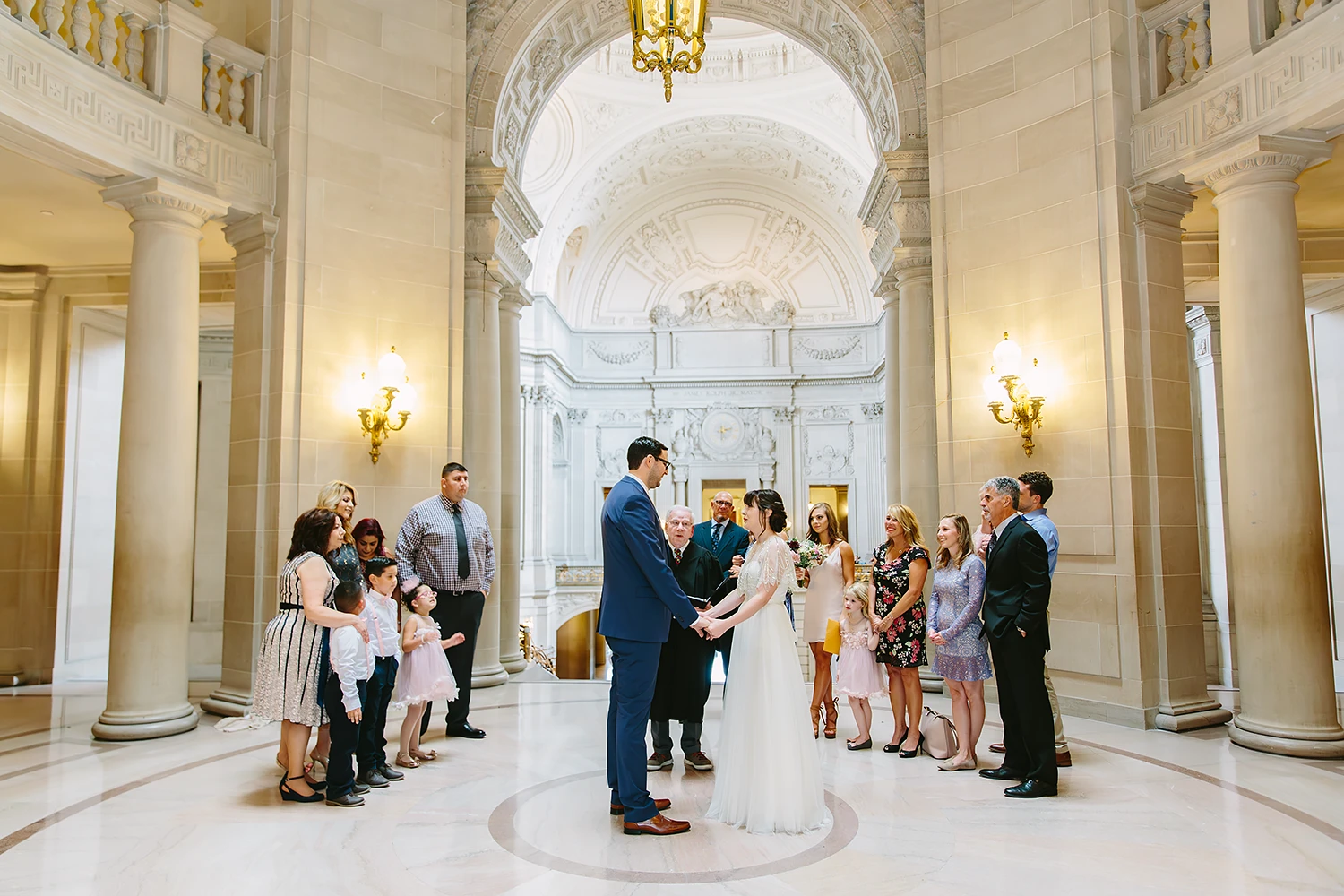 SF City Hall civil ceremony in the Rotunda. Family members watch bride and groom get married