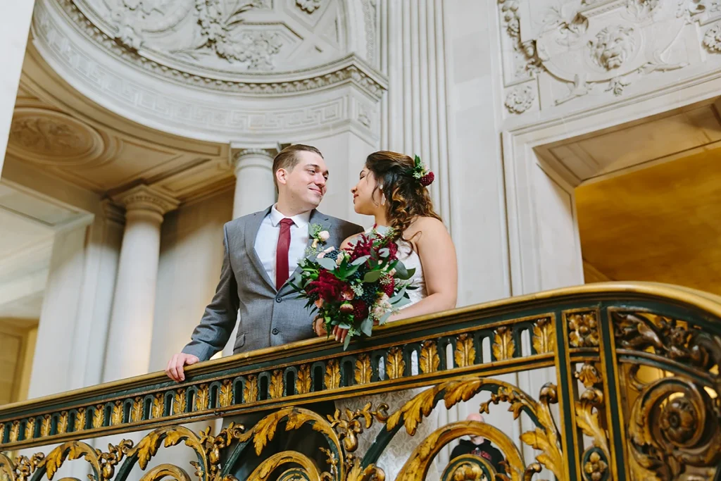 Bride and groom on City Hall balcony