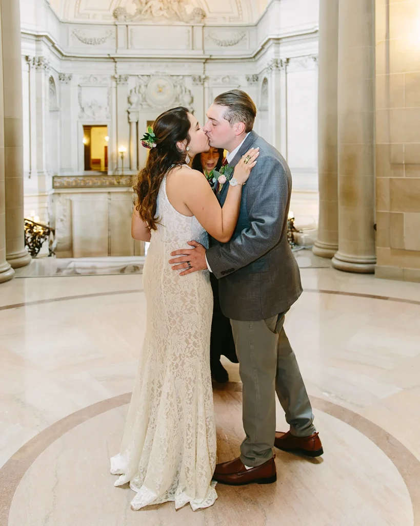 Bride and groom kiss during ceremony