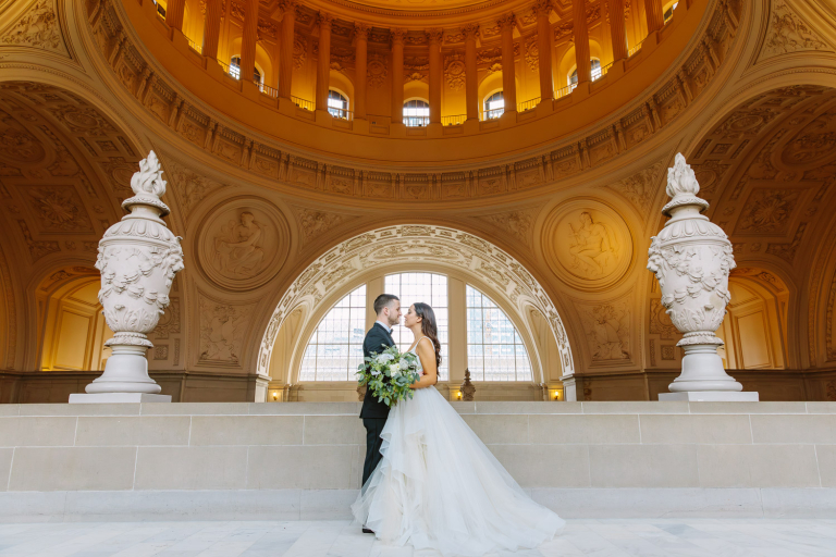 Bride and groom stand together at their San Francisco City Hall Fourth Floor weddings