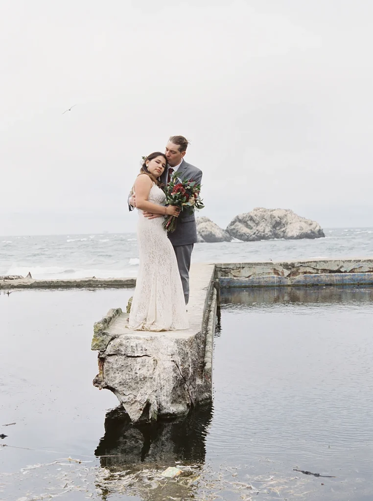 Bride and groom hug at Sutro Baths wedding in San Francisco