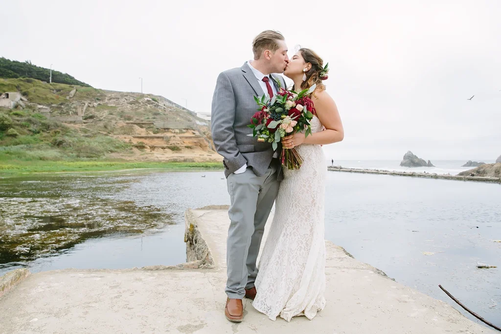 Bride and groom kiss at their San Francisco Sutro Baths wedding