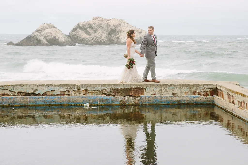 Couple walking together with their reflection in the water
