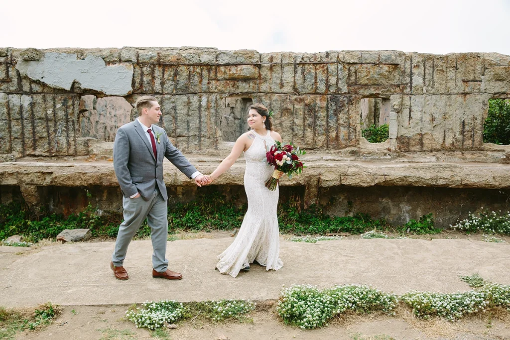Couple walk together at Sutro Baths in San Francisco